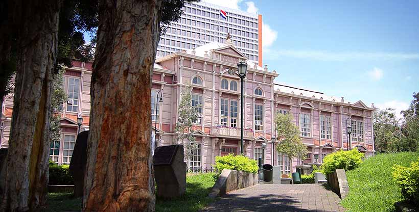 International schoolhouse in a city with a park and garden.