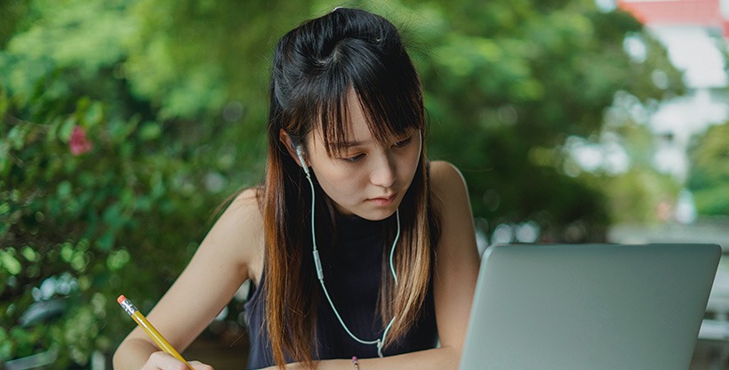 A woman on a laptop learning about the tax laws in the UK.
