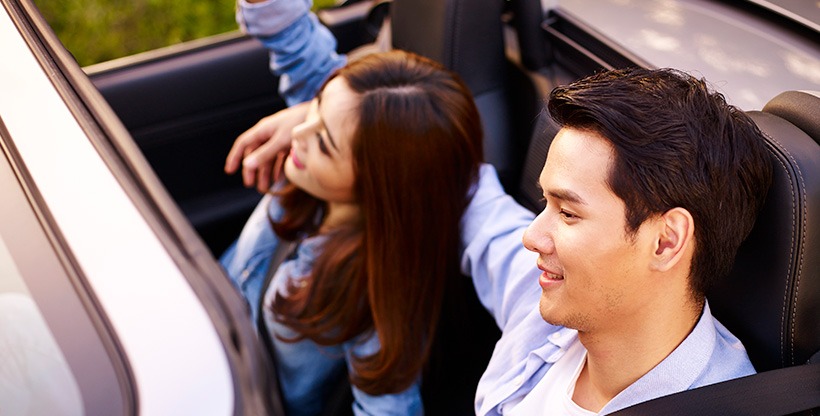 Asian couple drives their sport car in the UK.