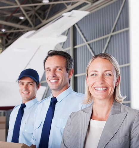 Aviation crew stand in hangar for airplanes.