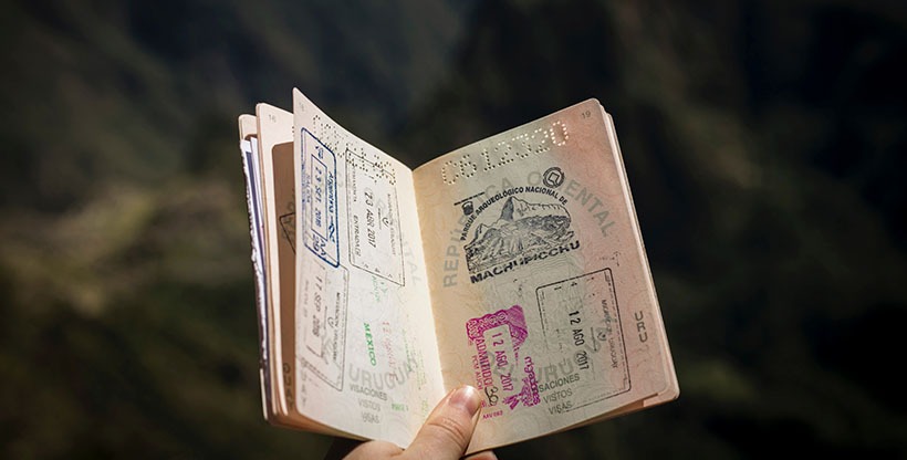 Expat's passport with many countrie's visa stamps inside.