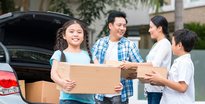 Family packs their car for their move overseas.