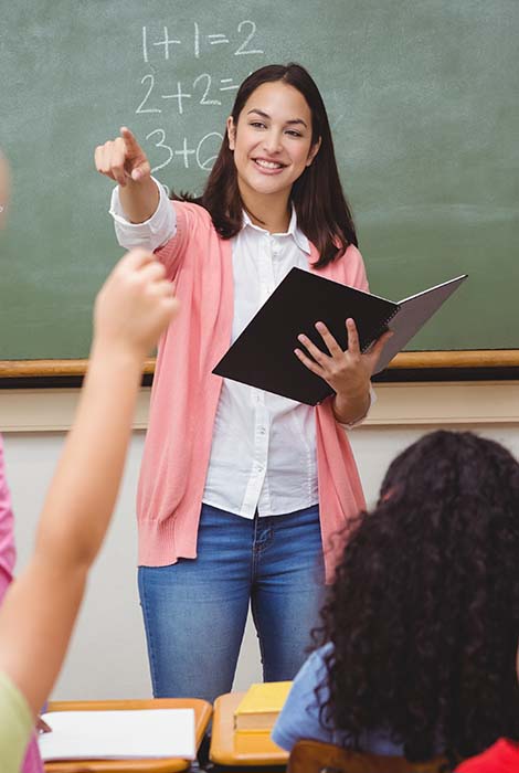 Math teacher points to choose a student out of a sea of raised hands.