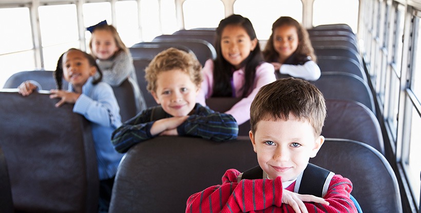 School bus full of excited students readyto  go on an excursion.