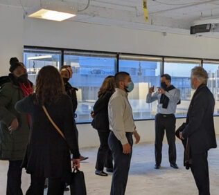 Teams explore and discuss the new Clements office space.