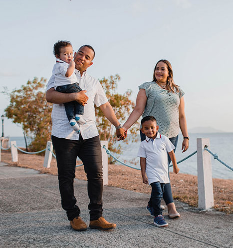 Family of four go for a peaceful walk on the beach.