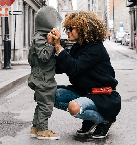 Mother and child share a special moment on a city street.