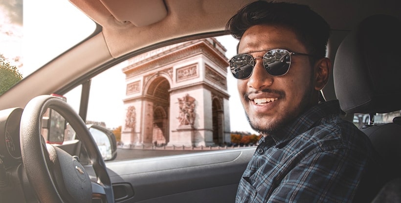A driver parks in front of the Arc de Triomphe in France, where the minimum legal limit of insurance is third-party liability.