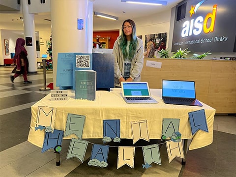 Saha with her guidebook, "New City, New Issues," addressing the mental health challenges faced by transient teens in the Foreign Service.